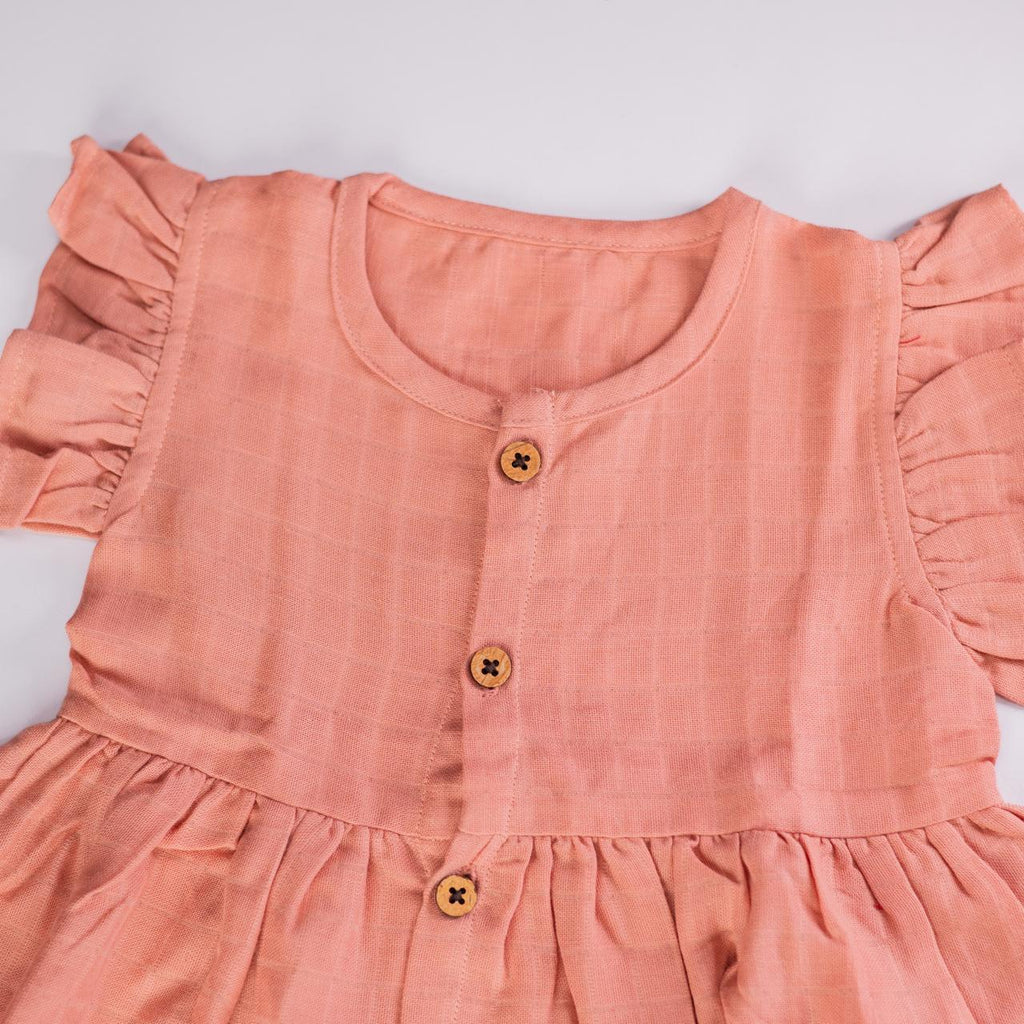 Peach Muslin Baby Frock with Wooden Buttons – Soft & Stylish