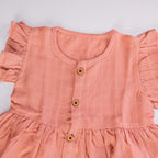 Peach Muslin Baby Frock with Wooden Buttons – Soft & Stylish