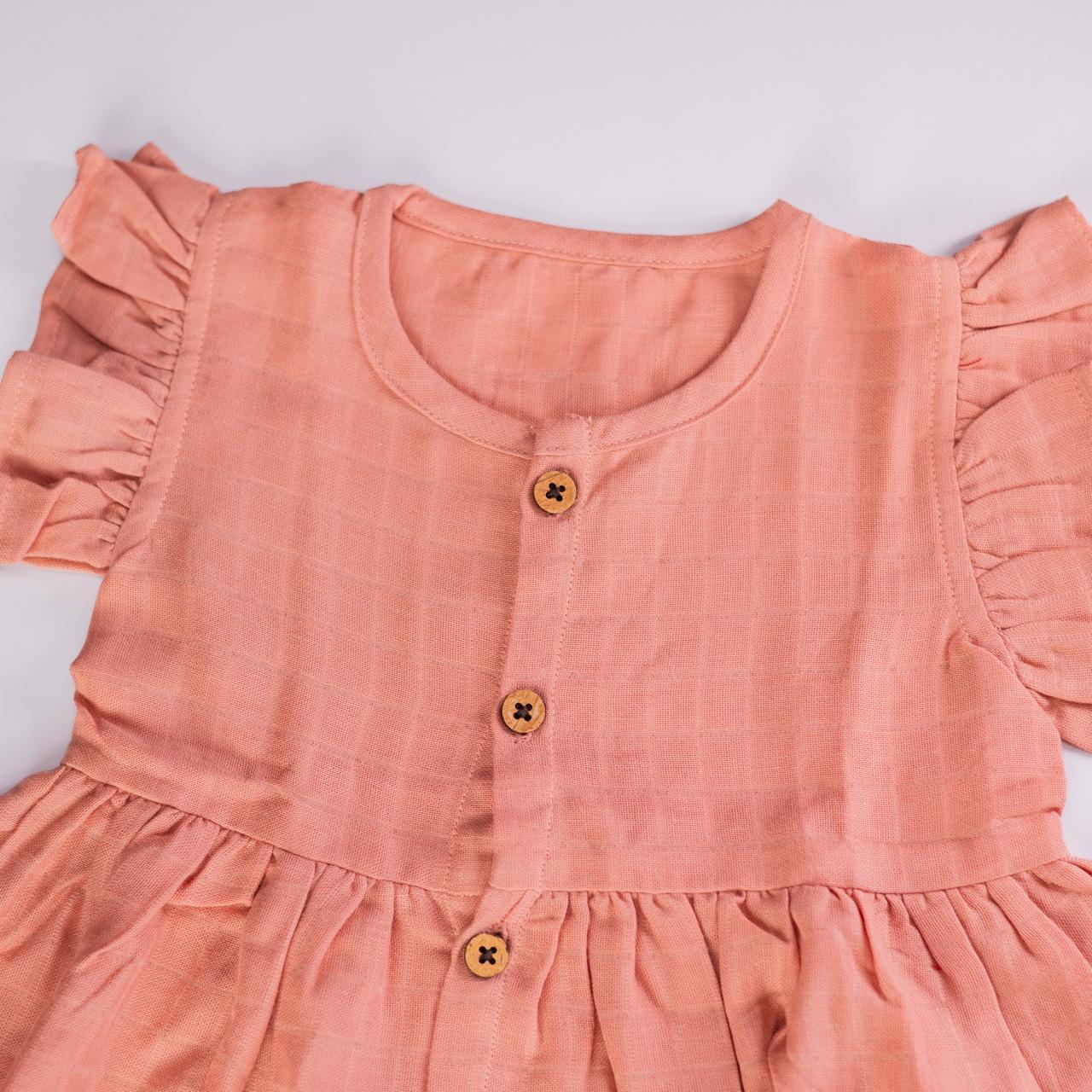 Peach Muslin Baby Frock with Wooden Buttons – Soft & Stylish