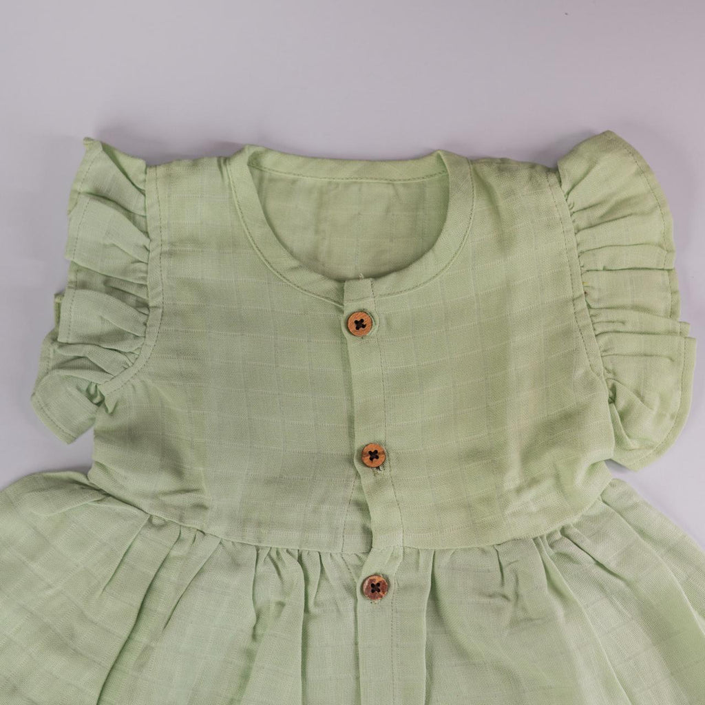Pista Green Muslin Baby Frock with Wooden Buttons – Soft & Stylish