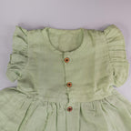 Pista Green Muslin Baby Frock with Wooden Buttons – Soft & Stylish