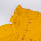 Mustard Yellow Muslin Baby Frock with Wooden Buttons – Soft & Stylish