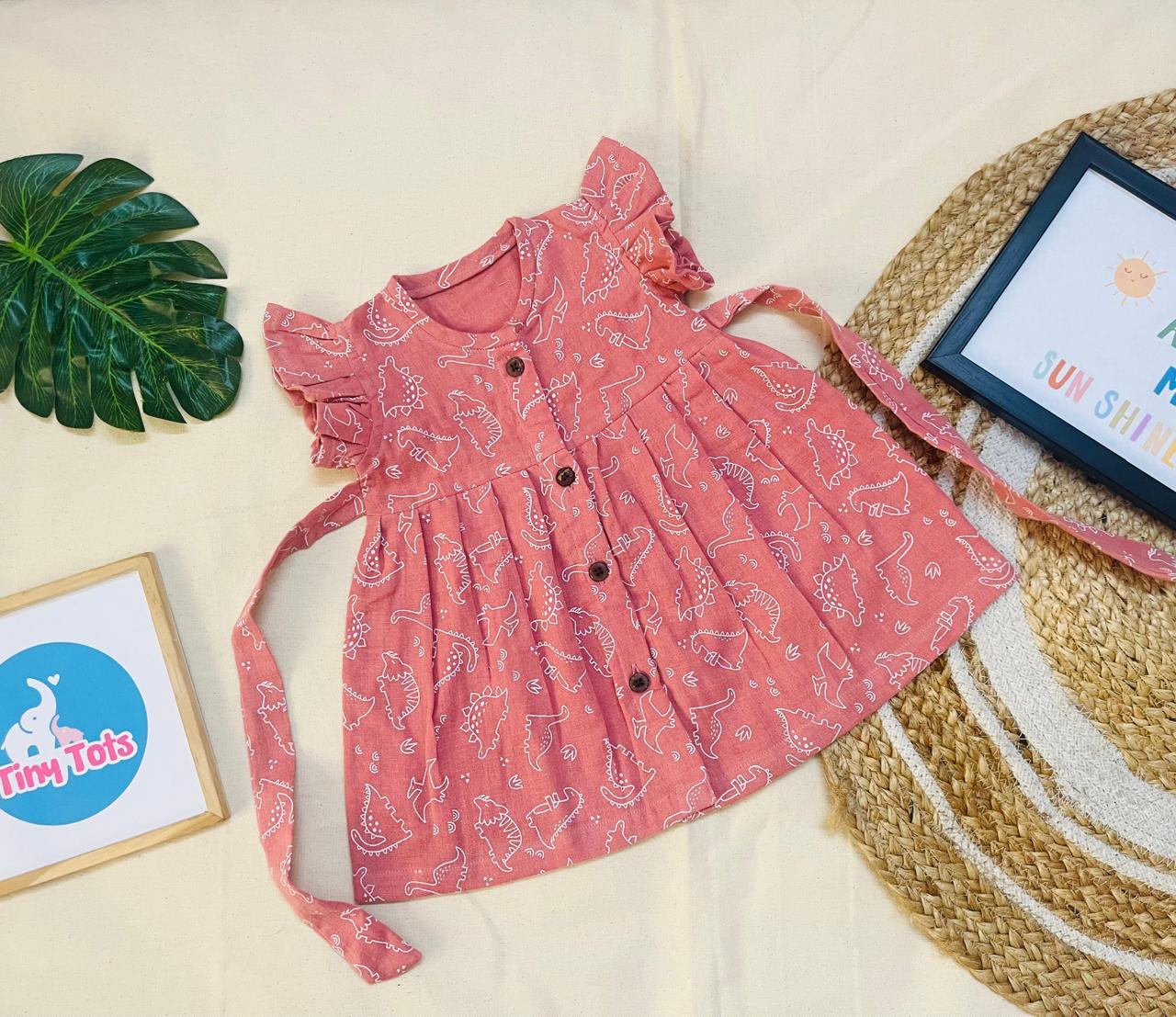 Pink Dino Muslin Baby Frock with Wooden Buttons – Soft & Stylish