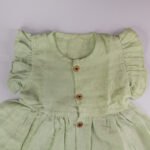 Pista Green Muslin Baby Frock with Wooden Buttons – Soft & Stylish - Image 2